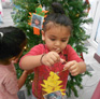 Little Dalrling Childcare decorating a Christmas tree