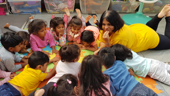 Children at Little Darlings Nursery in a huddle.